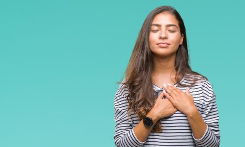 Woman with her hand over heart signifying what it means to be truthful because of her discipline to do God's will and tell the truth.