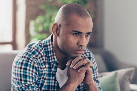 Contemplative young man pondering walking in God's will by ordering his priorities with discipline in obedience and discipleship for the glorification of God