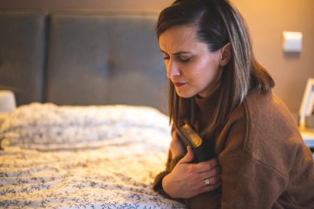 Woman clutching her Bible determined to have the focus and disipline to not just listen to the Word of God but to live out the commitment to obey it in discipleship to Christ through prayer and Bible study